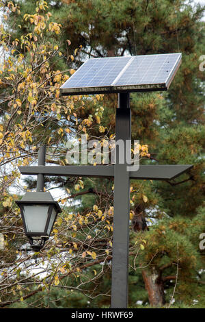 Street lighting pole with solar panel. Decorative lamp in the park with solar panel. Stock Photo