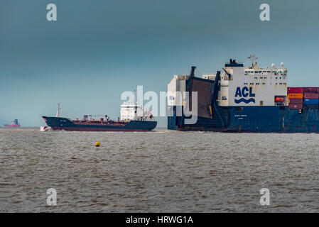 Container ship ACL Atlantic Conveyor leaving the port of Liverpool on the ruver Mersey passing Crosby beach. Stock Photo