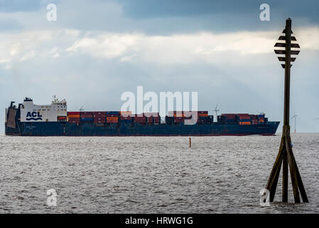 Container ship ACL Atlantic Conveyor leaving the port of Liverpool on the ruver Mersey passing Crosby beach. Stock Photo