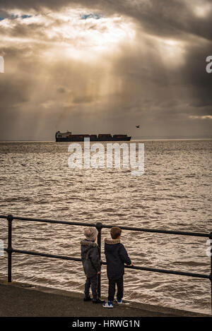 Container ship ACL Atlantic Conveyor leaving the port of Liverpool on the ruver Mersey passing Crosby beach. Stock Photo