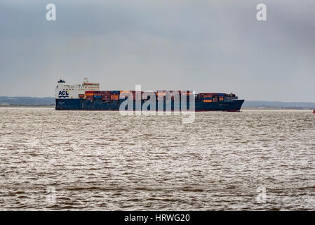 Container ship ACL Atlantic Conveyor leaving the port of Liverpool on the ruver Mersey passing Crosby beach. Stock Photo