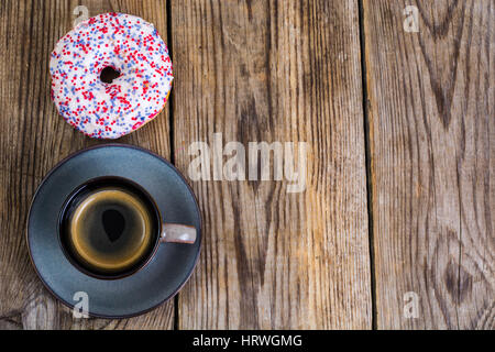 One donut with white frosting and colored sprinkles candy. Studio Photo Stock Photo