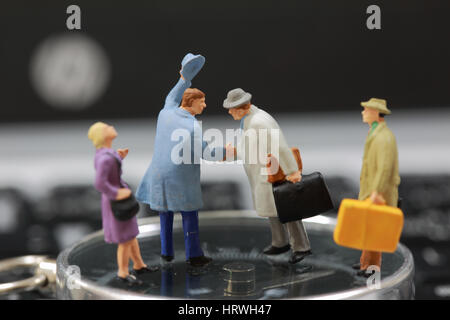 Selective focus of miniature tourist handshake as welcome and travel concept. Stock Photo