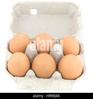 Six chicken eggs in an open carton isolated on white. Stock Photo