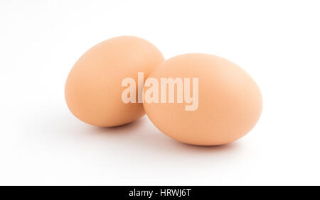 Two brown chicken eggs isolated on a white background. Stock Photo