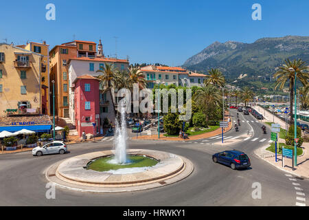 MENTON, FRANCE - JUNE 13, 2013: Roundabout with fountain in Menton - small town situated on French Riviera on Mediterranean sea. It is popular tourist Stock Photo