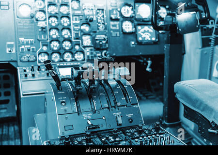 Airplan control stick in side pilot cockpit. Engine lever in the cockpit of an airliner. Center console and throttles in an airplane Stock Photo