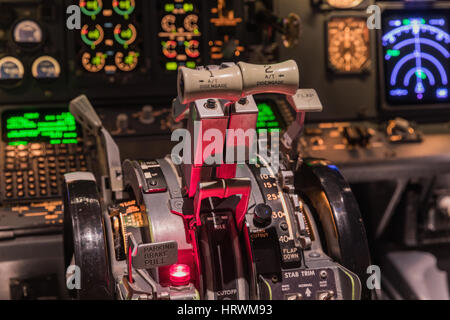 Airplan control stick in side pilot cockpit. Engine lever in the cockpit of an airliner. Center console and throttles in an airplane Stock Photo