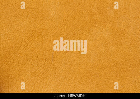Texture of genuine leather close-up, cowhide. Soft sunny orange color. For natural, artisan backgrounds, substrate composition use, vintage design Stock Photo