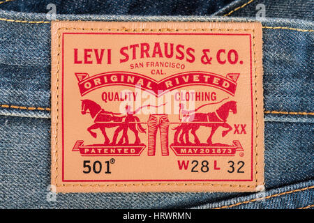 BANGKOK, THAILAND - DECEMBER 09 2014: Close up of the LEVI'S leather label on the blue jeans. LEVI'S is a brand name of Levi Strauss and Co, founded in 1853. Stock Photo