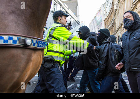 Bristol, UK. 4th March, 2017. Police hold back anti-fascist protesters. There were numerous scuffles between police and both far-right protesters and anti-fascist protesters as police kept the two groups apart. The far-right group were protesting outside Bristol Crown Court at the prison sentence received by Kevin 'bunny' Crehan for throwing bacon at a mosque. Crehan died in prison in December. Bristol, UK. 4th March 2017. Credit: Redorbital Photography/Alamy Live News Credit: Redorbital Photography/Alamy Live News Stock Photo