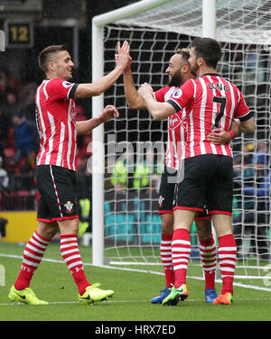Southampton's Nathan Redmond (centre) celebrates scoring his side's fourth goal with team-mates Dusan Tadic (left) and Shane Long during the Premier League match at Vicarage Road, Watford. Stock Photo