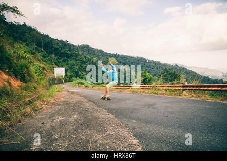 man longboarding extremely in tropics vacation Stock Photo