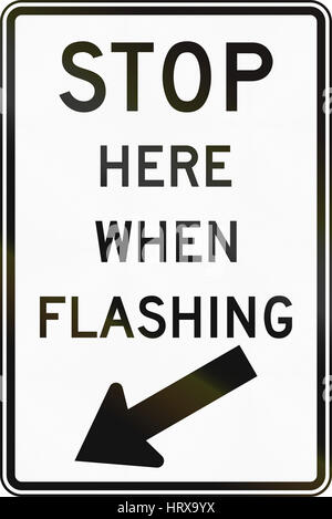 United States MUTCD regulatory road sign - Stop here when flashing. Stock Photo