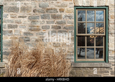 green window frame in stone building wall Stock Photo