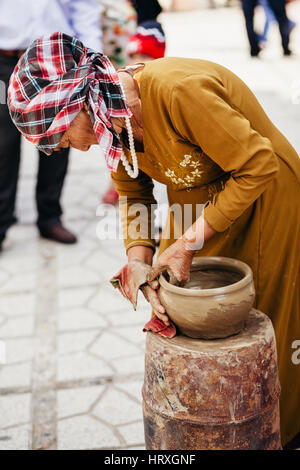 Nha Trang, VIETNAM - CIRCA February 2015 - unidentified woman creates clay pot  traditional handicraft in Vietnam Stock Photo