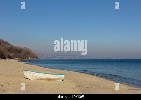 Day landscape of lonely boat on the beach Stock Photo