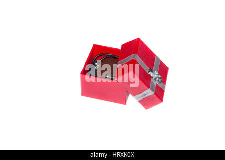 Single red gift box and gift with silver ribbon on white background. Stock Photo