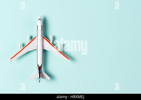 White toy plane on light blue background. Top view Stock Photo