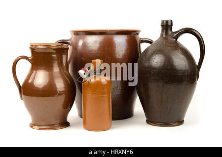 Old stoneware bottles and clay jug isolated on white background Stock Photo