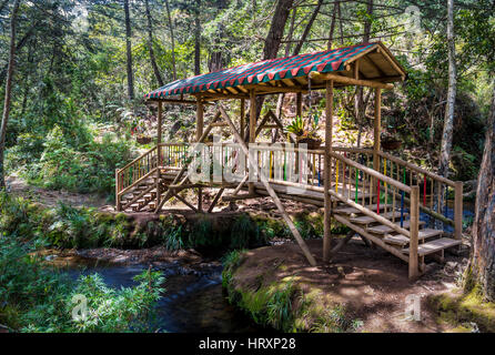 Small colorful covered wooden bridge  - Parque Arvi, Medellin, Colombia Stock Photo