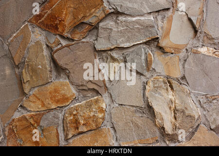 Textured wall background of gray and yellow stone Stock Photo