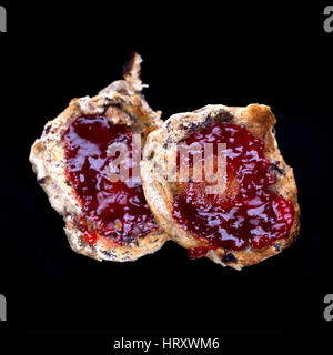 Toasted Teacakes with jam on a black background Stock Photo