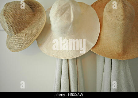 Hats hanging in a coastal holiday cottage Stock Photo