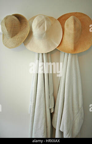 Hats hanging in a coastal holiday cottage Stock Photo