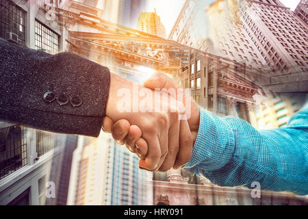 Double exposure of businessman handshake on New York City Wall Street background Stock Photo