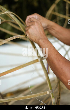 Man making object from bamboo by hand Stock Photo