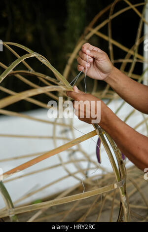 Man making object from bamboo by hand Stock Photo