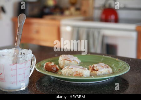 Cinnamon buns on plate on countertop Stock Photo