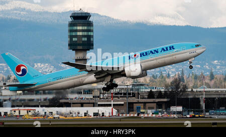 Korean Air Airlines plane airplane Boeing 777 (777-200ER) take taking off Vancouver International Airport airport control tower terminal scene Stock Photo
