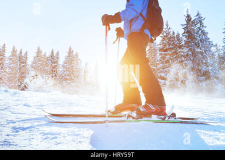 skiing downhill, skier in winter forest mountains, background Stock Photo