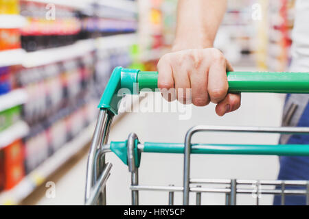 man in supermarket with the cart, food shopping Stock Photo