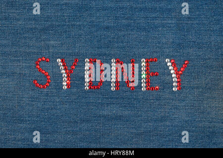 Inscription Sydney, inlaid rhinestones on denim. View from above Stock Photo