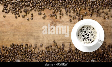 coffee beans background with cup on old rustic wooden table Stock Photo