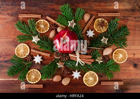 traditional christmas spices with red apple countrified decoration over wooden background Top view Stock Photo