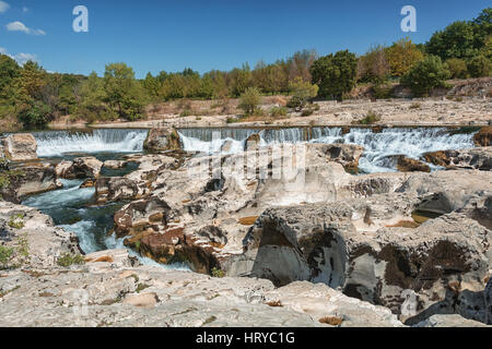 At the foot of the hill on which La Roque sur Cèze in France lies, swirl spectacular waterfalls and rapids of the Cascades du Sautadet. Stock Photo