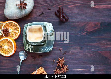 Coffee cup with dry citrus and star anise, a top view, an empty space on the right Stock Photo
