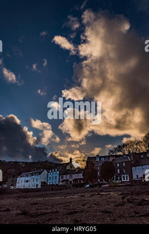 Sunset reflecting off clouds above Portree, March 2017, looking from the shore of Portree Harbolur, Isle of Skye, Scotland, UK Stock Photo