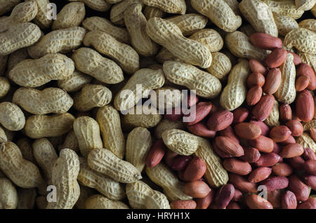 Raw peanuts in their shells an without shells Stock Photo