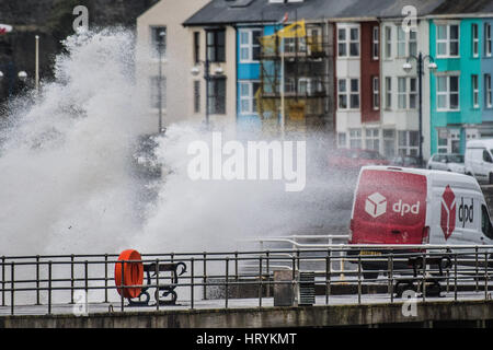 Aberystwyth, Wales, UK. 5th March, 2017.   UK Weather: On a day of increasingly strong winds, and with even more ferocious  gales forecast into the evening with the threat of snow on high ground,  mountainous high waves batter the promenade and sea defences and wash over a DPD courier's delivery van in Aberystwyth  on the Cardigan Bay coast of West Wales   photo © Keith Morris / Alamy Live News Stock Photo