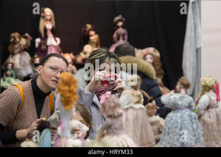 Moscow, Russia. 5th Mar, 2017. Visitors take pictures of dolls on display at a doll exposition in Moscow, Russia, March 5, 2017. Credit: Oleg Brusnikin/Xinhua/Alamy Live News Stock Photo