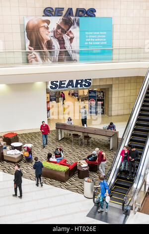 Fairfax, USA - February 18, 2017: Sears sign exterior in mall with escalator and closure sign Stock Photo