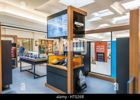 Fairfax, USA - February 18, 2017: Small Amazon store in mall with salesperson and products Stock Photo