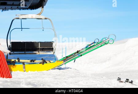 Empty rescue sleds standing next to chairlift at ski resort Stock Photo