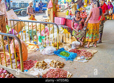 COLOMBO, SRI LANKA - DECEMBER 6, 2016: The side exits from Fose Market in Pettah occupied with small traders, offering vegetables for food and plantin Stock Photo