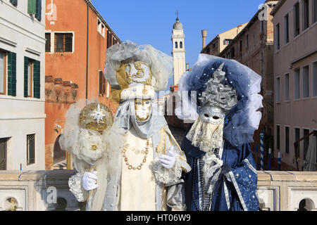 A couple in traditional Venetian costumes outside the San Giorgio dei Greci Church during the Carnival in Venice, Italy Stock Photo